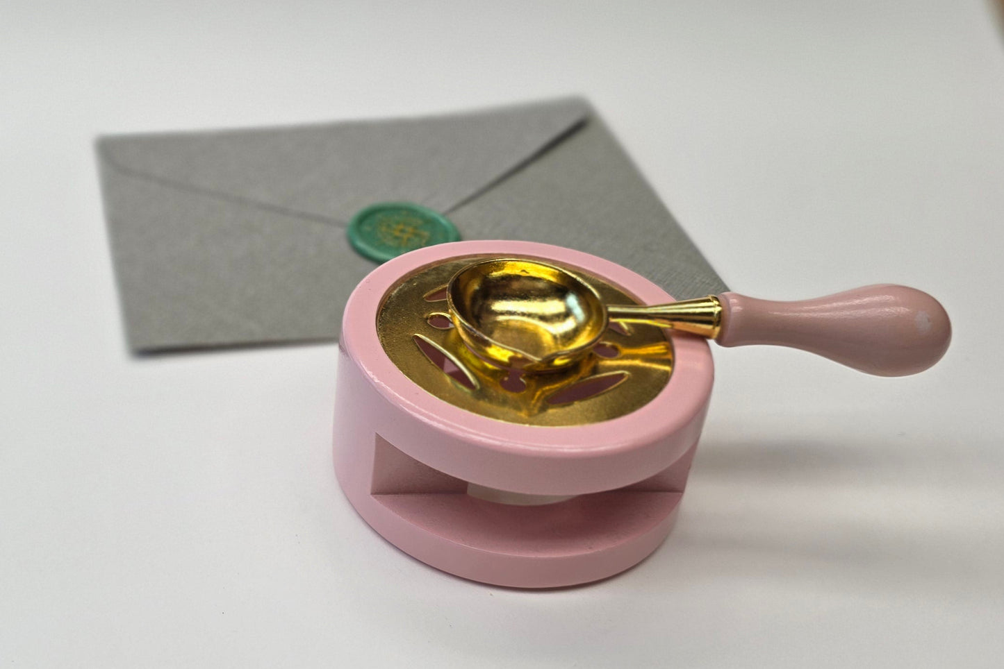 Pink sealing wax warmer and spoon