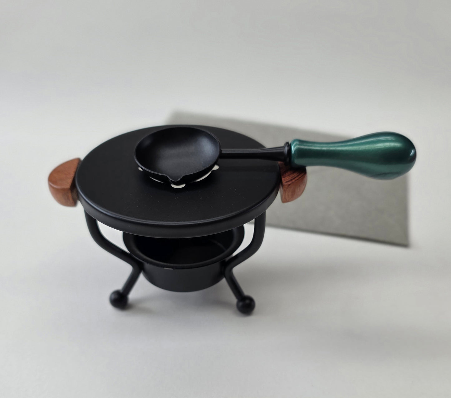 Black metal with wood handles warmer with spoon