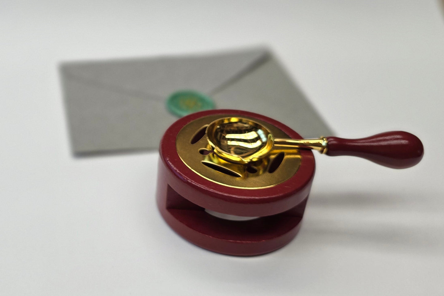 Reddish brown sealing wax warmer and spoon